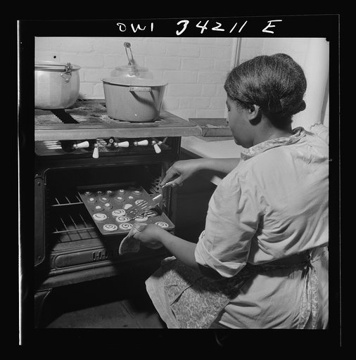 New Britain, Connecticut. A child care center opened September 15, 1942, for thirty children, ages two through five of mothers engaged in war industry. The hours are 6:30 a.m. to 6 p.m. six days per week. The dietician baking cookies