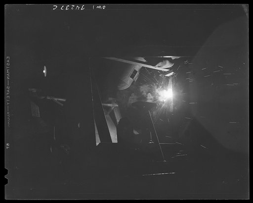 Untitled photo, possibly related to: New Britain, Connecticut. A welder at the Landers, Frary, and Clark plant working on a gun mounty