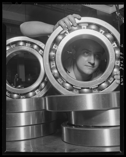New Britain, Connecticut. An inspector at the Fafnir Bearing Company inspecting large roller bearing which will probably end up in an Army tank