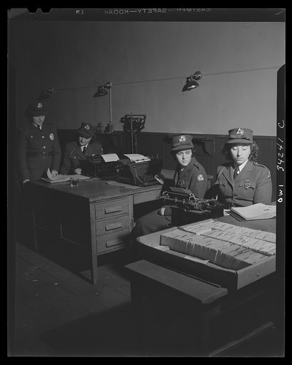 New Britain, Connecticut. New Britian auxiliary policewomen checking and writing out reports on their patrol duties