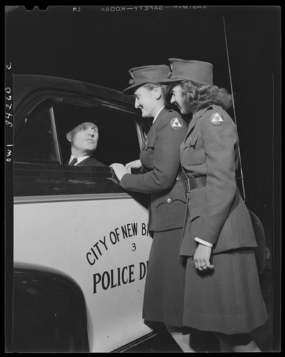 New Britain, Connecticut. Auxiliary policewomen and regular police working together during an emergency blackout
