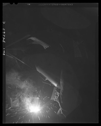 Untitled photo, possibly related to: New Britain, Connecticut. A welder at the Landers, Frary, and Clark plant working on a gun mounty