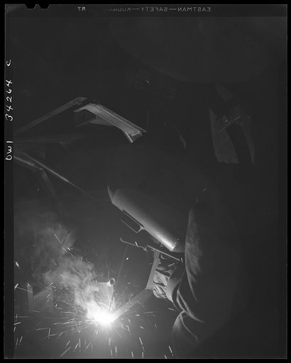 New Britain, Connecticut. A welder at the Landers, Frary, and Clark plant working on a gun mounty