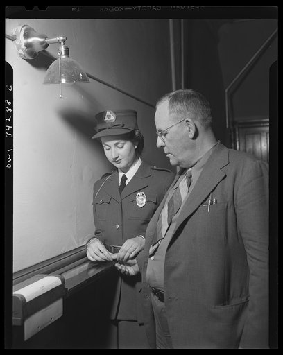 New Britain, Connecticut. Auxiliary policewomen taking fingerprints at the police station
