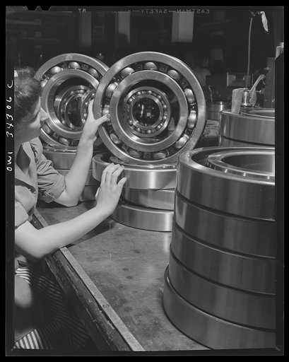 New Britain, Connecticut. An inspector at the Fafnir Bearing Company inspecting large roller bearing which will probably end up in an Army tank