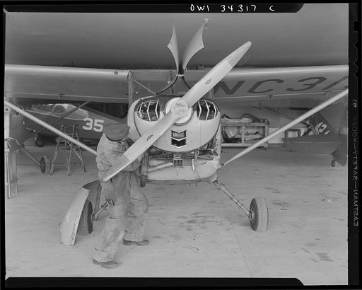 Bar Harbor, Maine. Civil Air Patrol base headquarters of coastal patrol no. 20. Ground crew making a routine check on a patrol plane