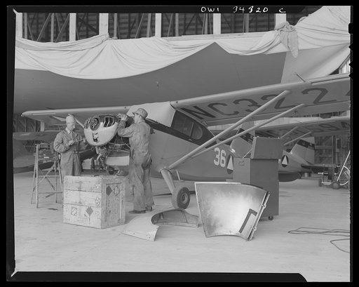 Bar Harbor, Maine. Civil Air Patrol base headquarters of coastal patrol no. 20. Ground crew making a routine check on a patrol plane