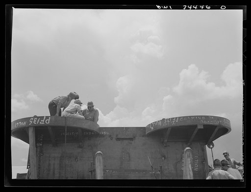Building foundations for anti-aircraft guns on a cargo vessel at the Higgins shipyards. New Orleans, Louisiana