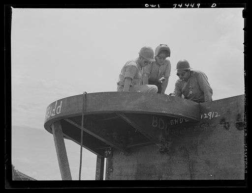 Building foundations for anti-aircraft guns on a cargo vessel at the Higgins shipyards. New Orleans, Louisiana