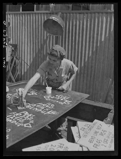 Numbering steel plates ready for installation. Higgins shipyards, New Orleans, Louisiana