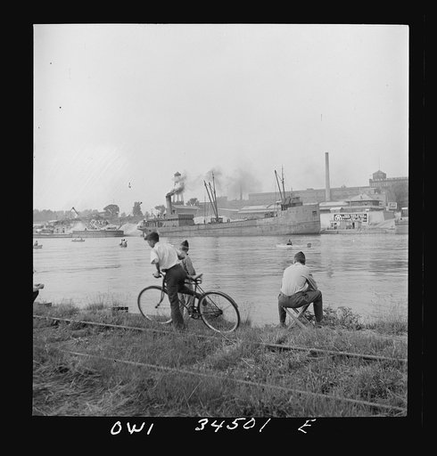 Untitled photo, possibly related to: Oswego, New York. Sunday fishermen on the Oewego River opposite the bauxite docks