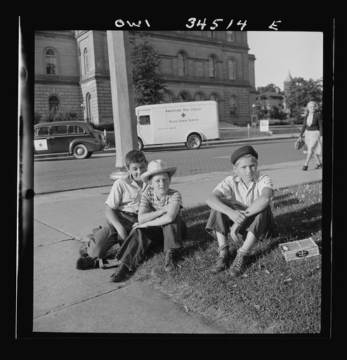 Oswego, New York. Boys recruited to work on the farms during the summer waiting to be picked up by the farmers at 7:30 a.m.