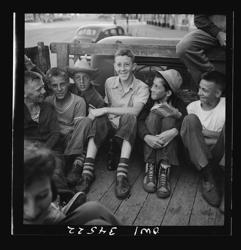 Oswego, New York. Children, recruited for farm work, waiting outside the U.S. Employment Service to start work for the summer
