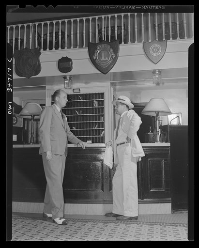 New Britain, Connecticut. Mr. Fred Lessing, manager of the Burritt Hotel, talking with a hotel guest