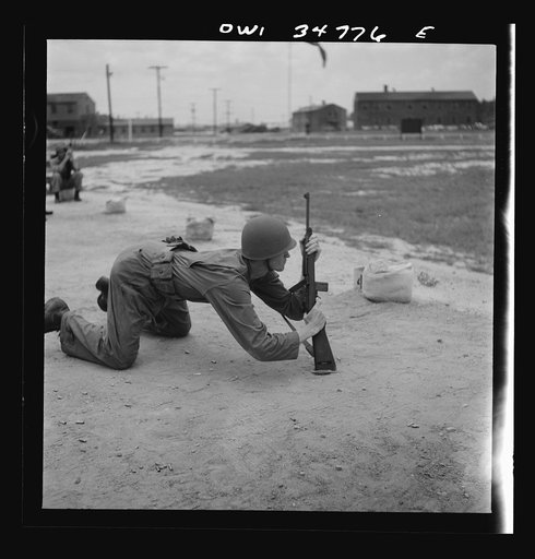 Untitled photo, possibly related to: Warner Robins, Georgia. Air Service Command, Robins Field. Practicing change from a sitting to a prone position with the carbine
