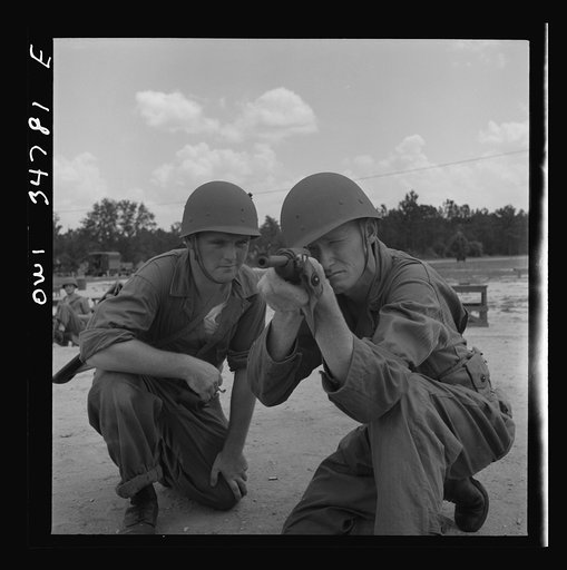 Warner Robins, Georgia. Air Service Command, Robins Field. Private Walter F. Guthrie, of Canadian, Texas, learning to handle a carbine. The instructor is Sergeant Dennis Maloney of Brooklyn, New York. Guthrie was a filling station operator in his home town; Maloney, a clerk in an A&P store. Both are