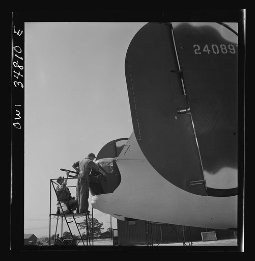 Untitled photo, possibly related to: Warner Robins, Georgia. Air Service Command, Robins Field. Mechanics of an air depot group removing the cowling of one of the engines of a B-24 Liberator bomber
