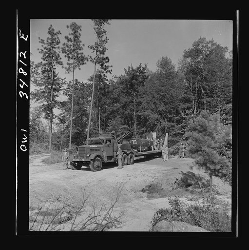 Warner Robins, Georgia. Air Service Command, Robins Field. Practicing picking up and loading of an old P-39 with a C3 truck and trailer