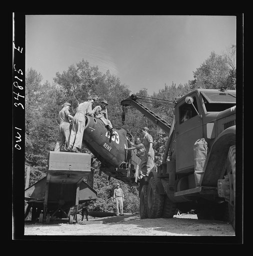 Warner Robins, Georgia. Air Service Command, Robins Field. Practicing picking up and loading of an old P-39 with a C3 truck and trailer