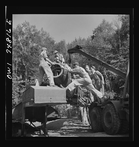 Warner Robins, Georgia. Air Service Command, Robins Field. Practicing picking up and loading of an old P-39 with a C3 truck and trailer