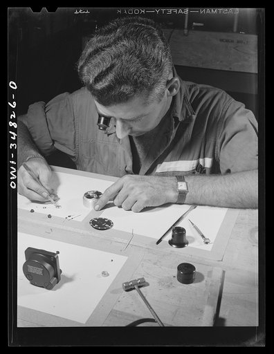 Warner Robins, Georgia. Air Service Command, Robins Field. Staff Sergeant C.A. Jones, an instrument repairman, working on an aircraft clock. Sergeant Jones comes from Lloyd, Florida