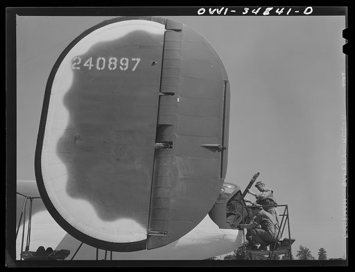 Warner Robins, Georgia. Air Service Command, Robins Field. Ordnance men of an air depot group working on the tail guns of a B-24 Liberator bomber