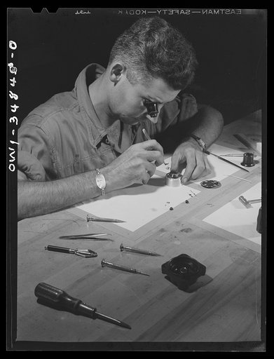 Warner Robins, Georgia. Air Service Command, Robins Field. Staff Sergeant C.A. Jones, an instrument repair man, working on an aircraft clock. Sergeant Jones comes from Lloyd, Florida