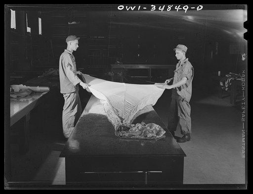 Warner Robins, Georgia. Air Service Command, Robins Field. Parachute men of an air depot group inspecting a parachute