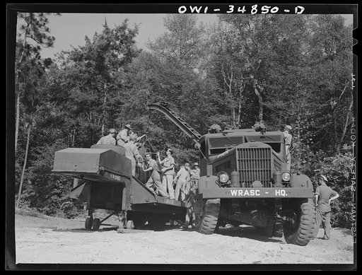 Untitled photo, possibly related to: Warner Robins, Georgia. Air Service Command, Robins Field. Practicing the loading of a simulated wreck onto a C-3 truck and trailer. An old P-39 was used for the demonstration