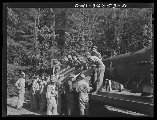 Warner Robins, Georgia. Air Service Command, Robins Field. Practicing the loading of a simulated wreck onto a C-3 truck and trailer. An old P-39 was used for the demonstration