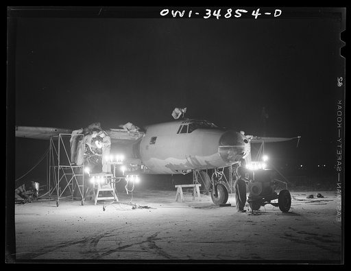 Warner Robins, Georgia. Air Service Command, Robins Field. Men of an air depot group working on a B-26 bomber at night