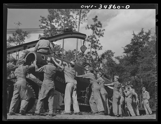 Warner Robins, Georgia. Air Service Command, Robins Field. Practicing the loading of a simulated wreck onto a C-3 truck and trailer. An old P-39 was used for the demonstration