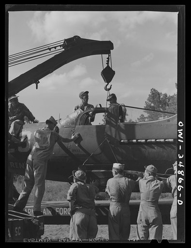 Warner Robins, Georgia. Air Service Command, Robins Field. Practicing the loading of a simulated wreck onto a C-3 truck and trailer. An old P-39 was used for the demonstration