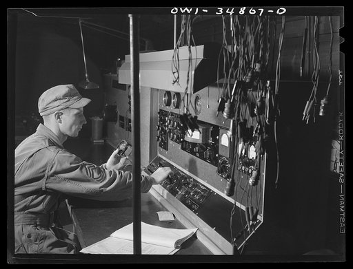 Warner Robins, Georgia. Air Service Command, Robins Field. Master Sergeant H.W. Halvorsen, an instrument repair man, checking instruments at electrical test panel. Sergeant Halvorsen comes from Washington, D.C.