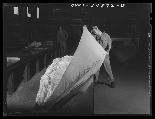 Warner Robins, Georgia. Air Service Command, Robins Field. Parachute men of an air depot group inspecting a parachute
