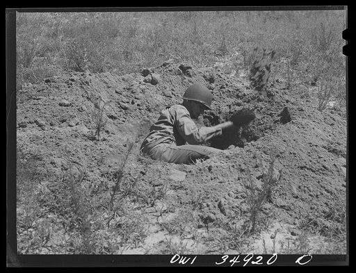 Untitled photo, possibly related to: Daniel Field, Georgia. Air Service Command. Learning to dig a foxhole in a hurry