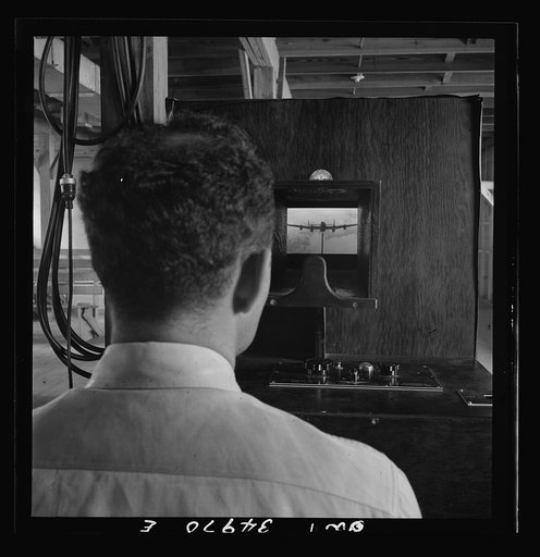 Untitled photo, possibly related to: Daniel Field, Georgia. Air Service Command. Learning to identify aircraft in a machine which shows models in various positions, against various colored backgrounds, at varying intensities of light and for short or long periods of time