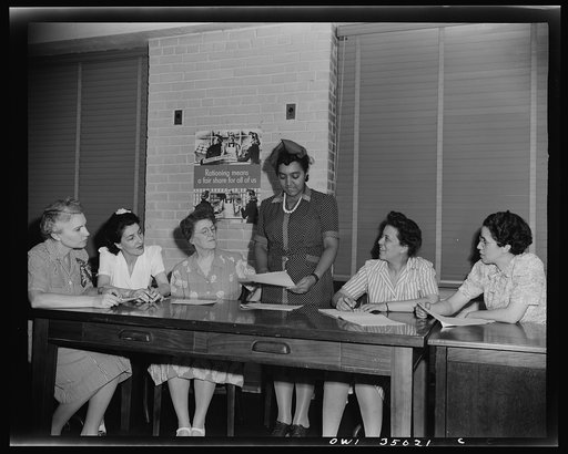 Newport News, Virginia. Mrs. Ethel R. Stephens, organizer of the Consumer Interest Council, a group of Negro housewives at Newport News, making a report to the members of the Special Services Section of the Office of Price Administration, concerning point rationing. Left to right: Mrs. M. Barr, Miss