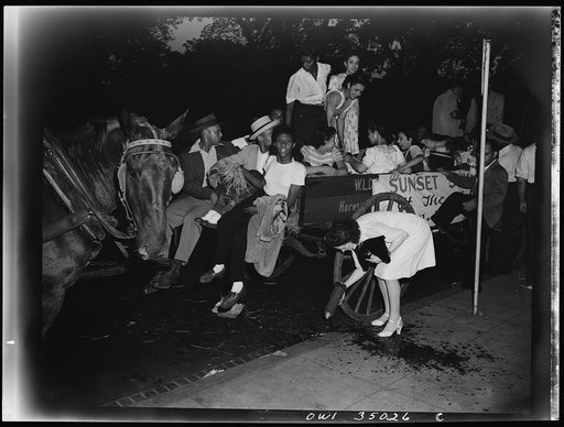 Washington, D.C. A group of Washington Negro war workers leaving the United Service Organization (USO) branch of the Young Men's Christian Association (YMCA). Because of the gas rationing they are using horses and wagons for their hayride