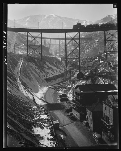 Bingham Copper Mine, Utah. Carr Fork Canyon as seen from "G" bridge. In the background can be seen a train with waste or over-burden material on its way to the dump