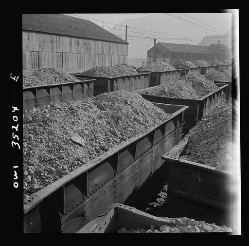 Trains of ore containing copper arriving at one of the large refining plants of the Utah Copper Company