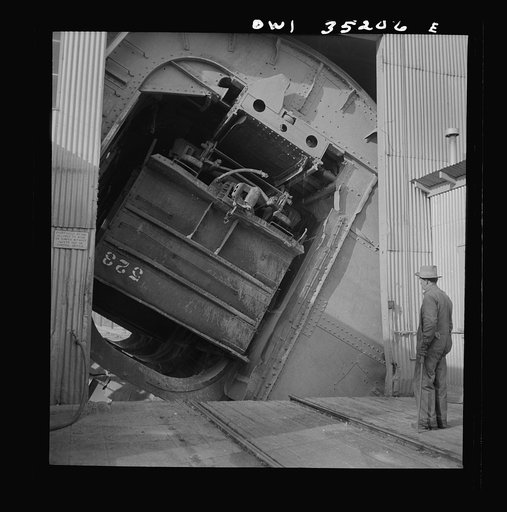 Untitled photo, possibly related to: Magna, Utah. A rotary car dumper discharging copper ore at the mill