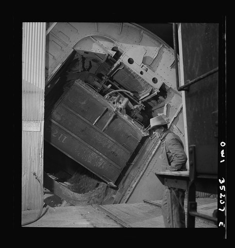 Untitled photo, possibly related to: Magna, Utah. A rotary car dumper discharging copper ore at the mill