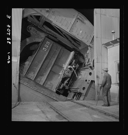 Untitled photo, possibly related to: Magna, Utah. A rotary car dumper discharging copper ore at the mill