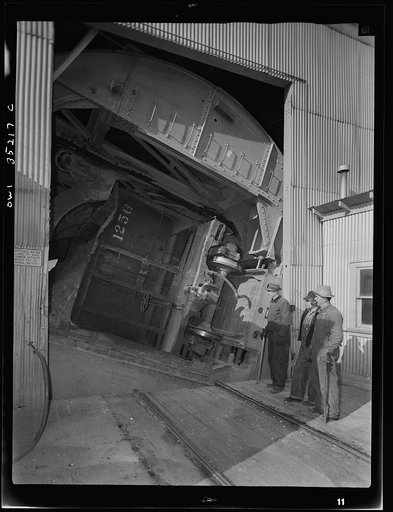 Untitled photo, possibly related to: Magna, Utah. A rotary car dumper discharging copper ore at the mill