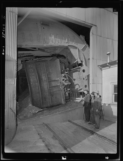 Untitled photo, possibly related to: Magna, Utah. A rotary car dumper discharging copper ore at the mill