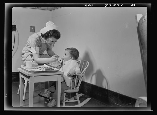 Johns Hopkins Hospital, Baltimore, Maryland. A student nurse feeding a convalescent youngster