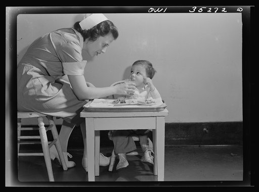Johns Hopkins Hospital, Baltimore, Maryland. A student nurse feeding a convalescent youngster