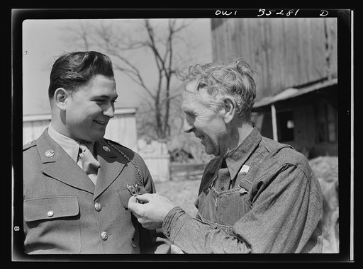 Rockville (vicinity), Maryland. Private Harvey Horton, visiting the N.C. Stiles dairy farm while on furlough from Fort Belvoir, Virginia with farmer Stiles who is questioning him about his medals