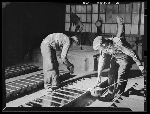 San Francisco, California. Pouring tin "pigs" at the metal and thermite company. The metal has been reclaimed from tin cans